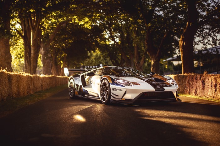 Ford GT Mk II race car on a tree-lined road