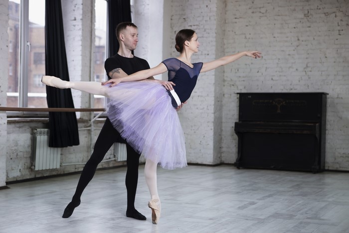 Ballet dancers in a studio with a piano