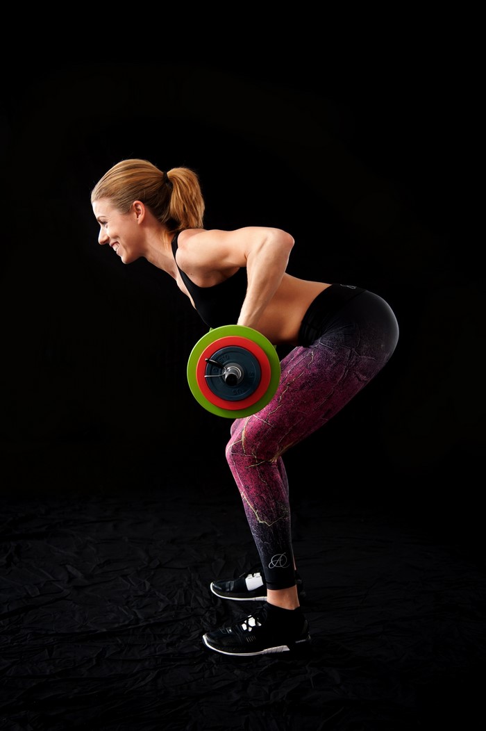 Woman performing barbell row exercise