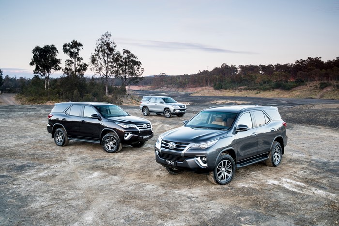 Three Toyota Fortuner SUVs in a landscape