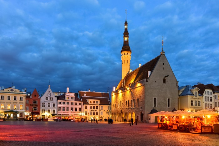 Tallinn Town Hall Square at dusk with outdoor cafes