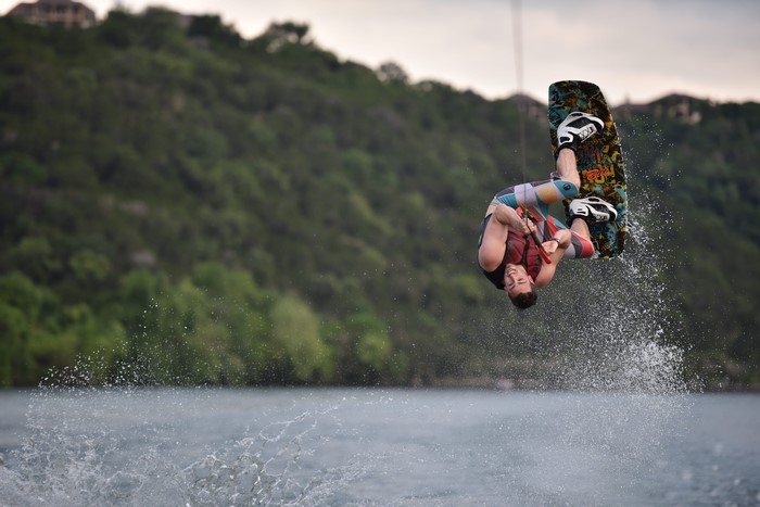 Man wakeboarding and jumping over water