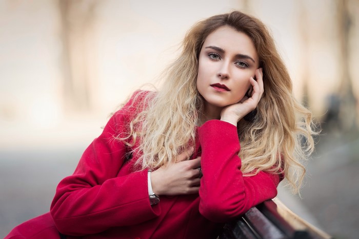 Woman in red coat with blonde hair