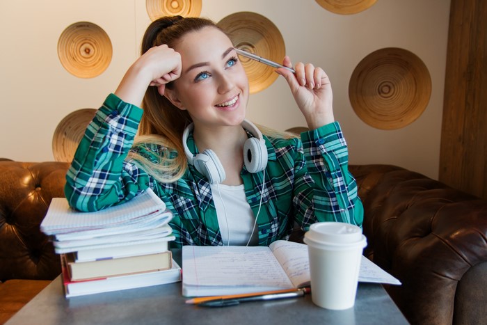 Female student with headphones and books
