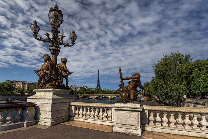 Sculptures and Eiffel Tower on a bridge in Paris