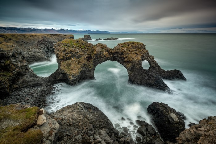 Sea arch and rocky coast in Iceland