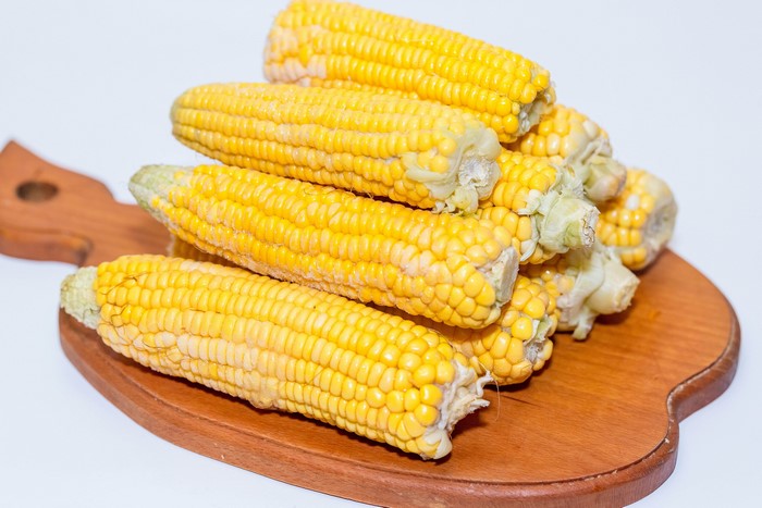 Pile of Corn on a Wooden Cutting Board