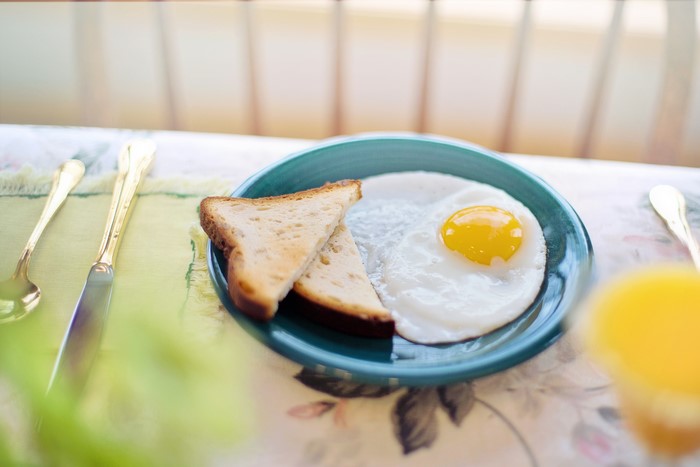 Fried egg with toast on a plate
