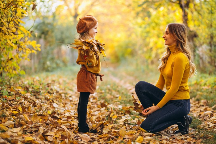 Mother and daughter in autumn park