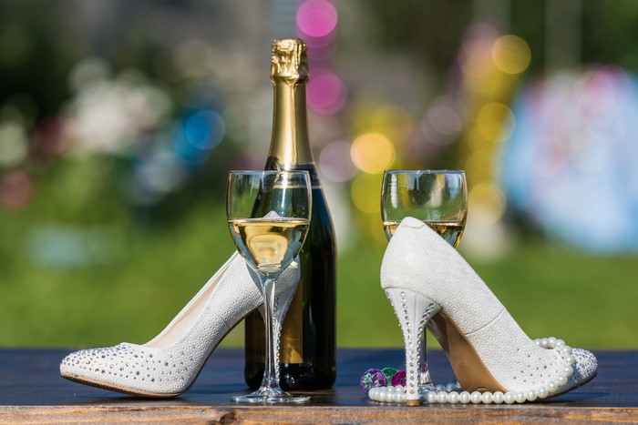 Champagne bottle and glasses with stilettos