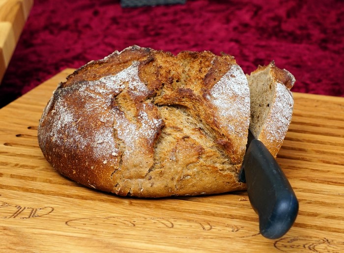 Bread on a cutting board with a knife