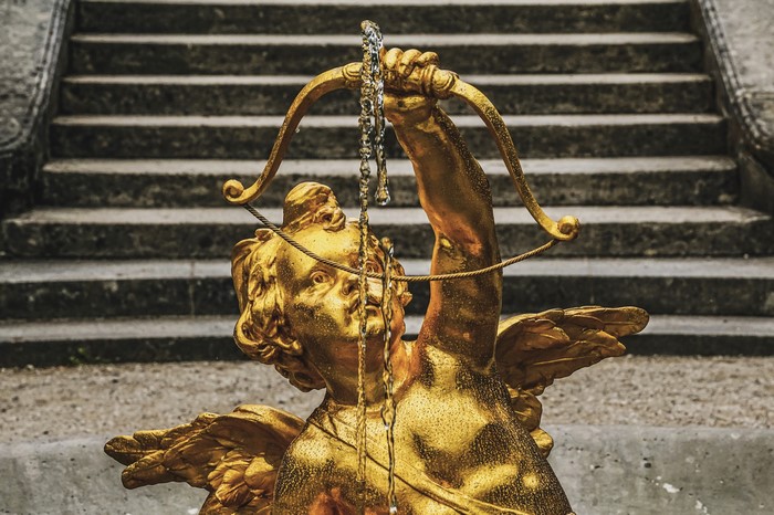Golden angel sculpture with bow and stairs