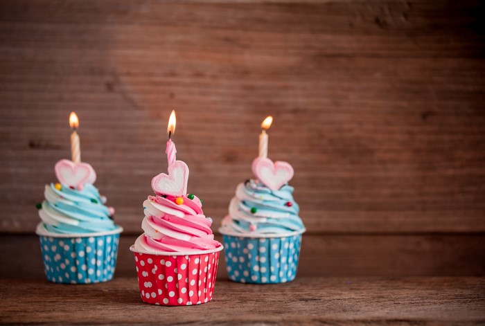 Three Cupcakes with Candles and Heart Toppings