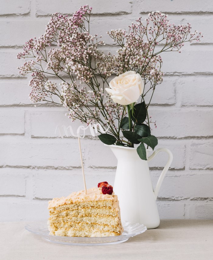 Slice of cake with flowers and 'Mom' topper