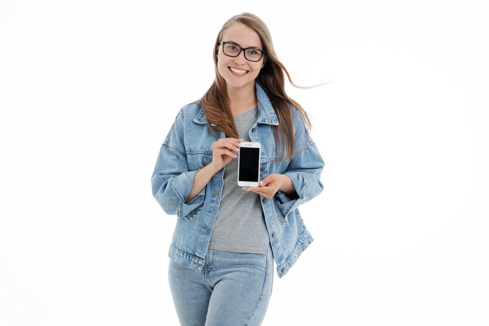 Woman in Denim Jacket Holding Smartphone