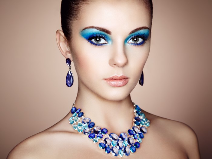Woman with blue makeup and jewelry