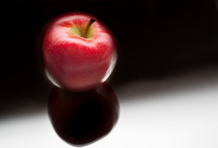 Red Apple on Reflective Surface