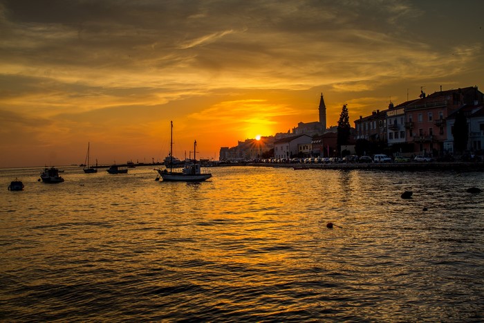 Sunset over Rovinj, Croatia with boats in marina