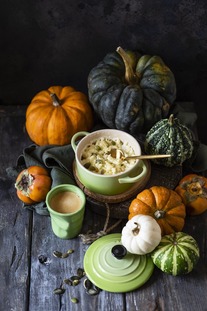 Porridge with pumpkin and persimmons on wooden planks