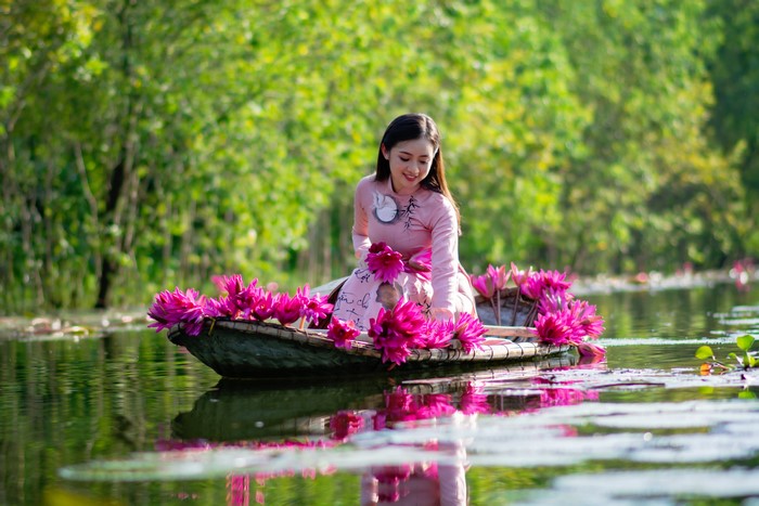 Woman in a boat with water lilies