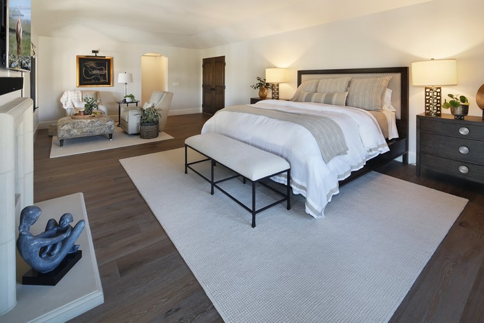 Bedroom with bed, seating area, and fireplace