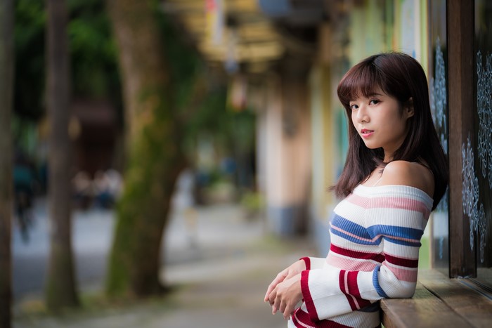 Asian woman with brown hair in a striped sweater