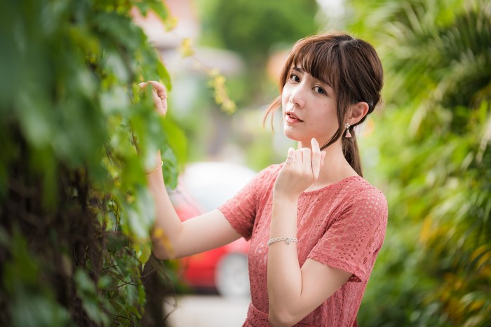 Asian woman with brown hair in a pink dress