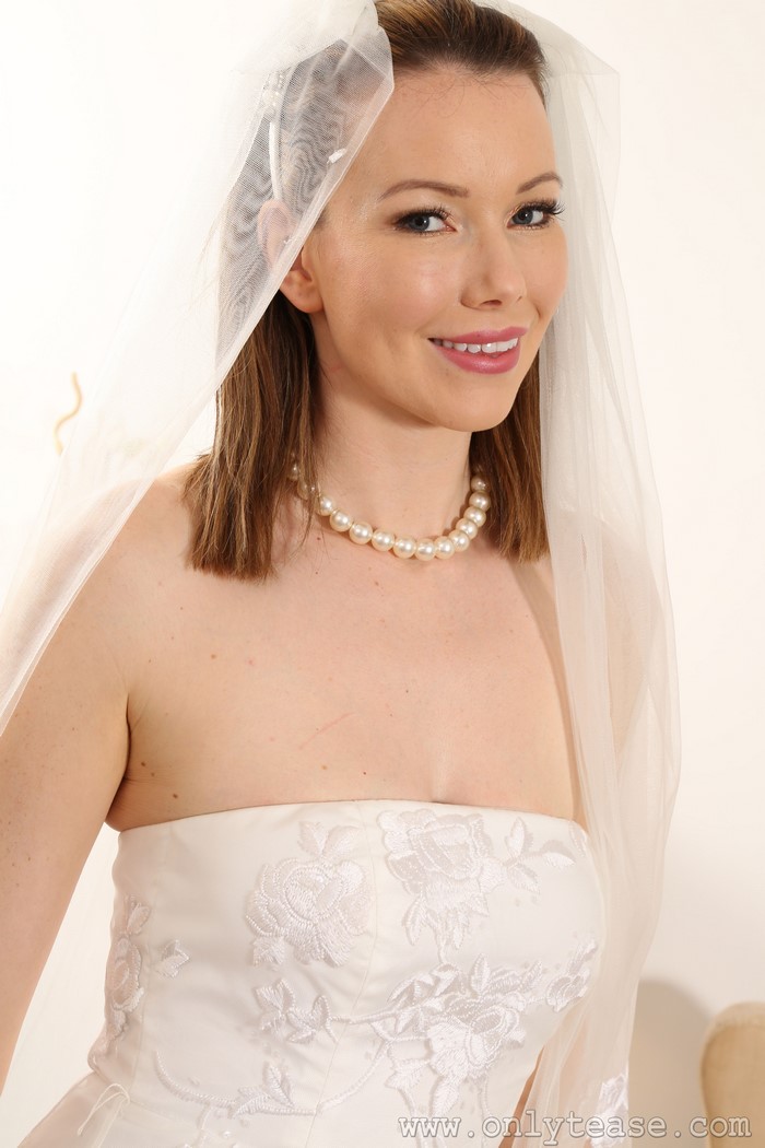 Nicky Phillips in a wedding dress with a pearl necklace