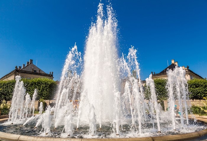 Fountain with buildings and trees in Copenhagen, Denmark