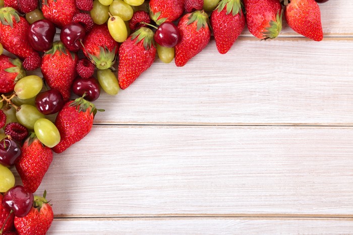 Strawberries, Cherries, and Grapes on Wood Planks