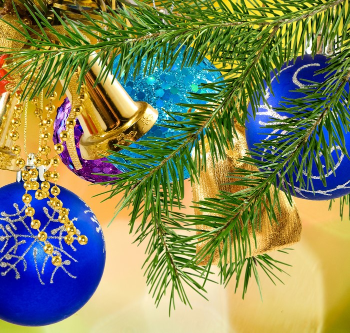 Christmas tree branches with blue and gold ornaments