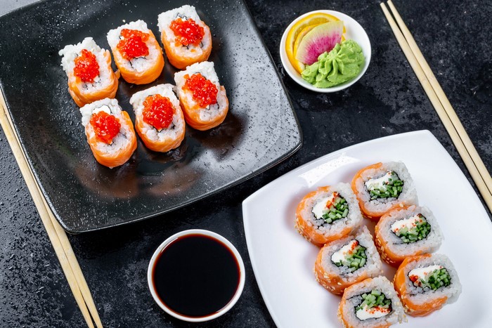 Sushi with salmon, caviar, and cucumber rolls with soy sauce and wasabi