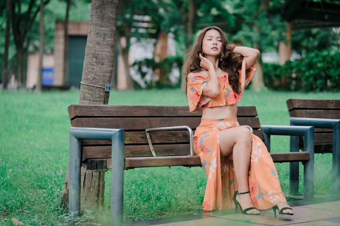 4K Elegant Woman Sitting on a Park Bench