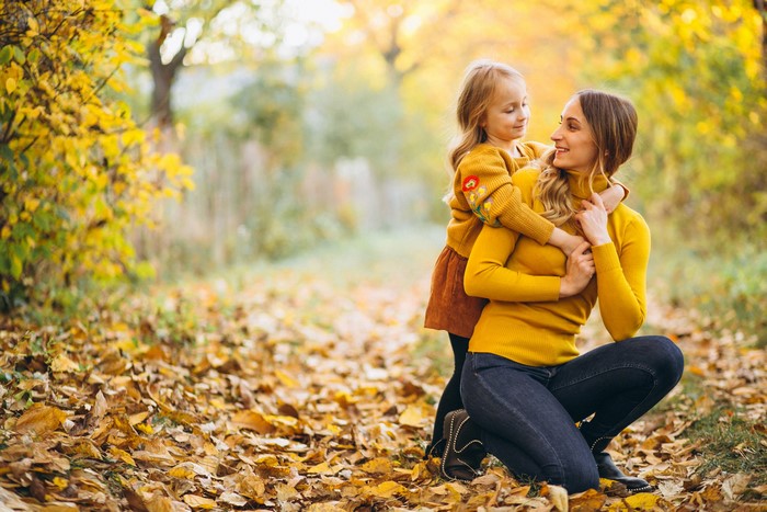Mother and daughter in autumn park