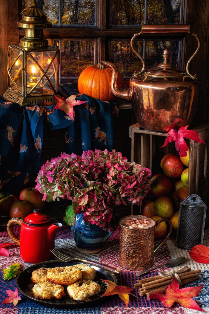 Autumn still life with pumpkin, kettle, and pastries