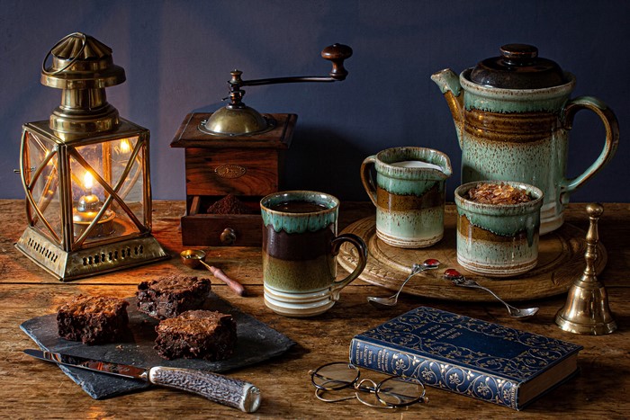 Still-life with coffee, brownies, and a lantern