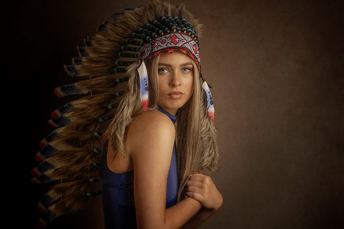 Woman wearing a Native American headdress
