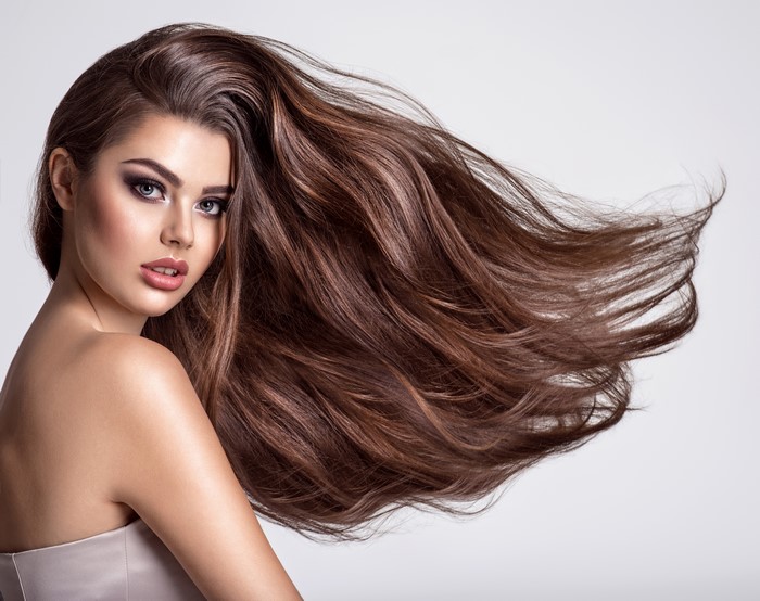 Beautiful woman with long brown hair and makeup