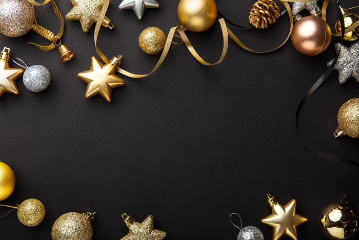 Christmas ornaments and ribbons on black background