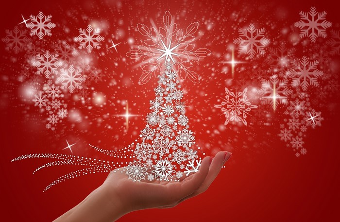 Christmas tree made of snowflakes held by a hand