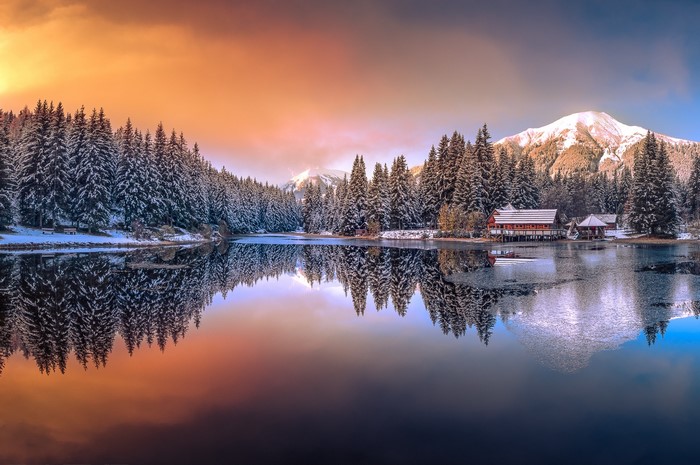 Winter lake with snow-covered trees and mountains in Austria