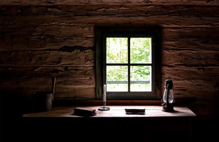 Cabin Interior with Window, Candle, and Lantern