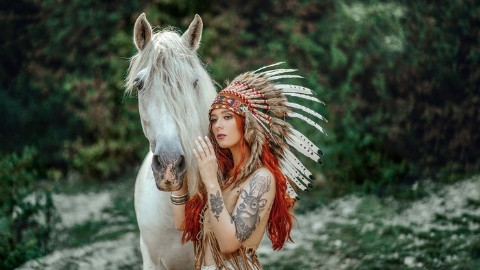 Woman in Native American Headdress with White Horse