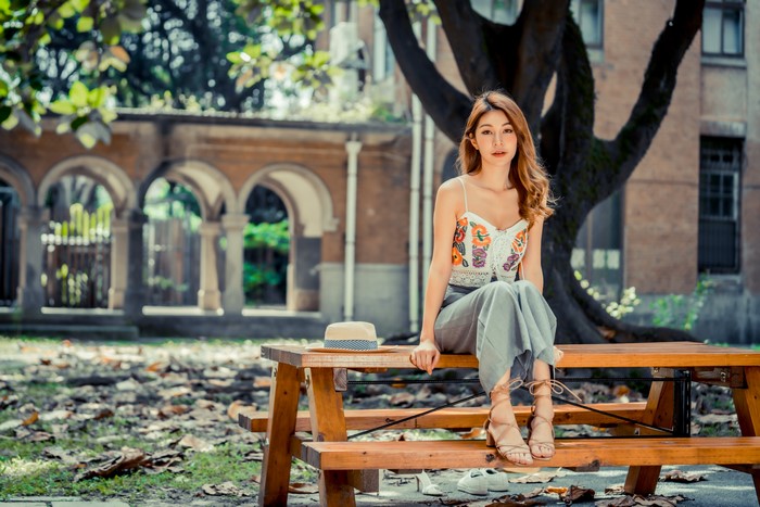 4K Asian Woman Sitting on Wooden Table