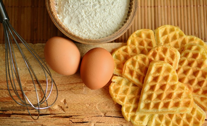 Heart-shaped waffles with flour and eggs