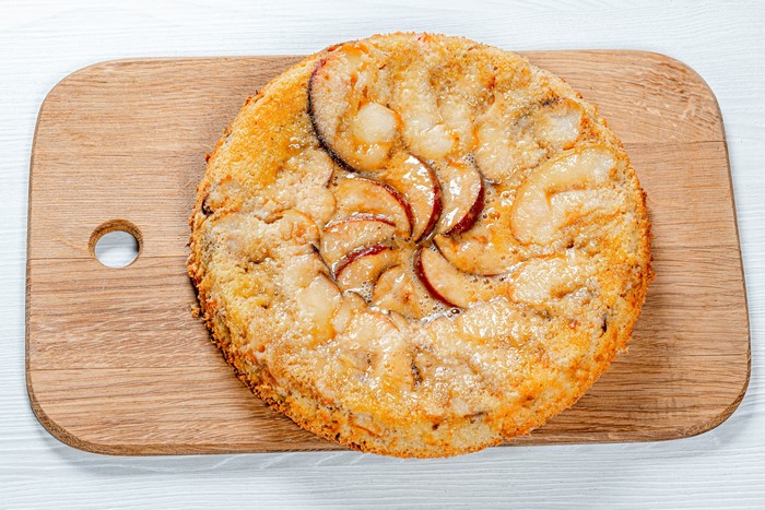 Apple cake on a wooden cutting board