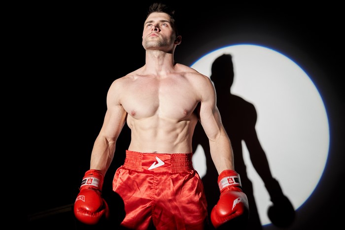 Boxer in red shorts and gloves