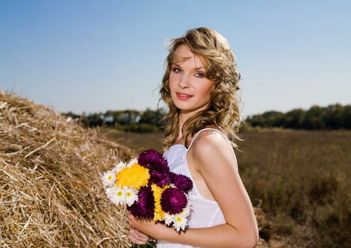 Woman with Bouquets near Straw Bale