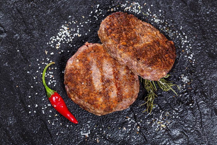 Two grilled Frikadeller with chili pepper and salt