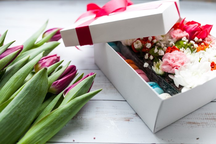 Tulips and a gift box with flowers and macarons